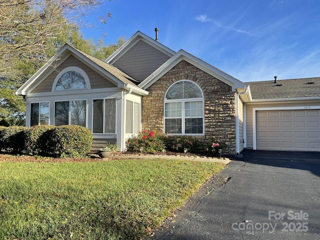 view of front facade with a garage and a front lawn