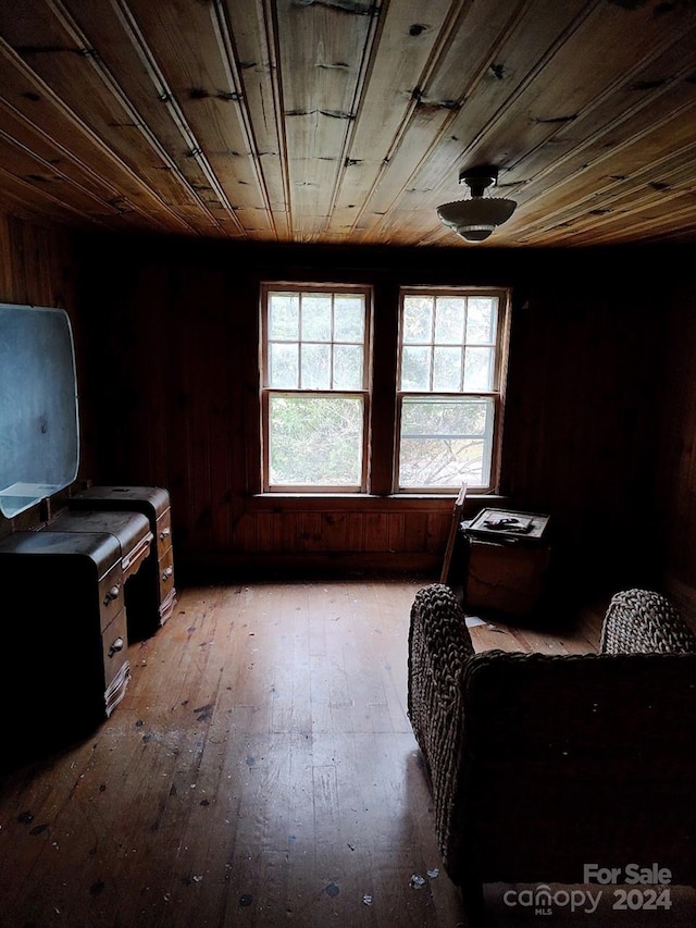 misc room with wooden ceiling, wood walls, and light wood-type flooring