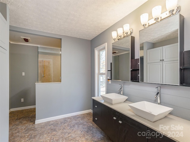 bathroom with vanity and a textured ceiling