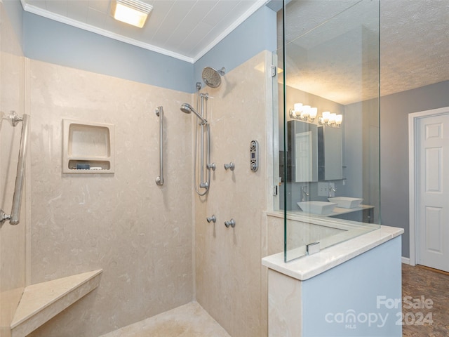 bathroom with vanity, a tile shower, and ornamental molding