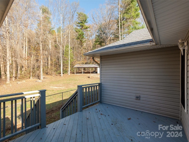 wooden deck featuring a yard