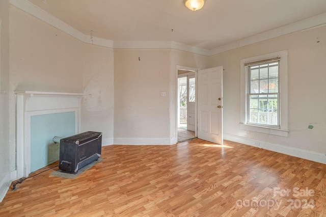 living room featuring light hardwood / wood-style floors and ornamental molding