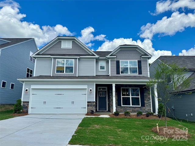 5115 Heathland Dr Unit 47, Charlotte, NC 28215 - craftsman inspired home with concrete driveway, a front yard, stone siding, an attached garage, and covered porch