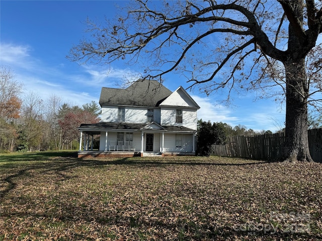 front of property with covered porch and a front lawn