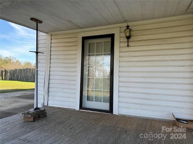 view of exterior entry featuring a deck