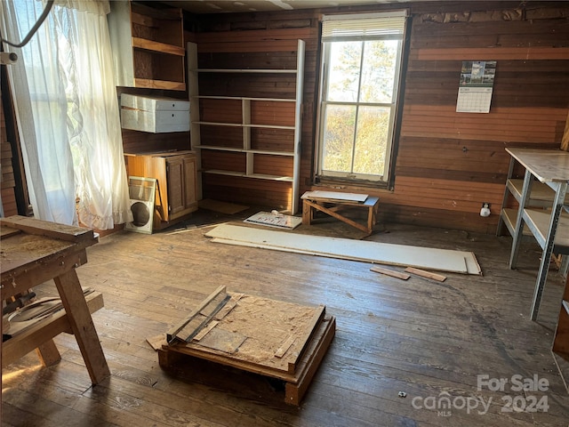 misc room featuring dark hardwood / wood-style floors and wooden walls