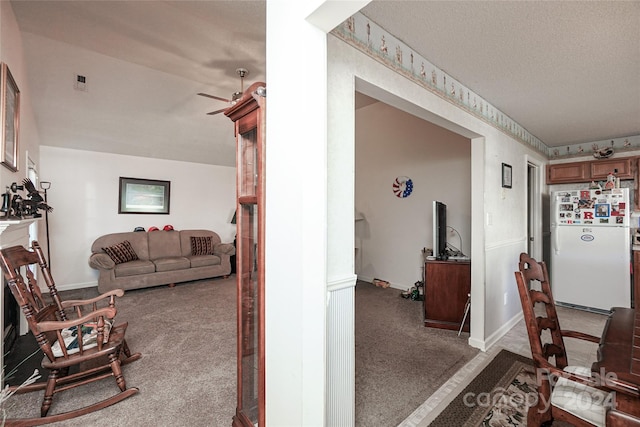 interior space featuring ceiling fan and a textured ceiling