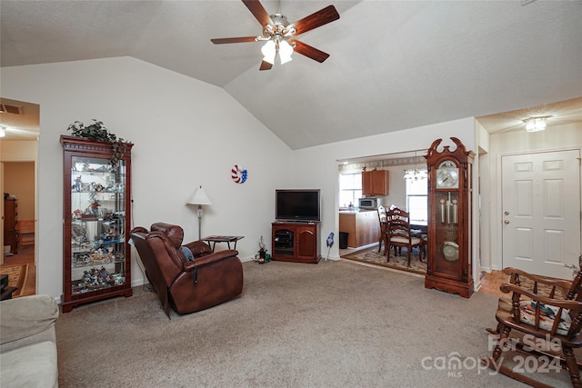 living room with vaulted ceiling, ceiling fan, and light carpet