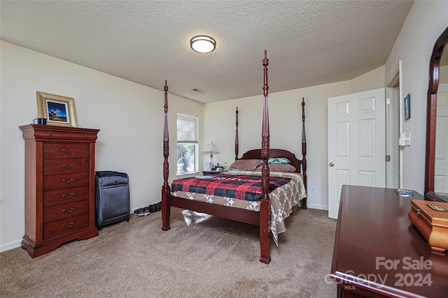 bedroom featuring light colored carpet and a textured ceiling