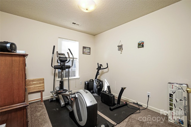 exercise room with a textured ceiling