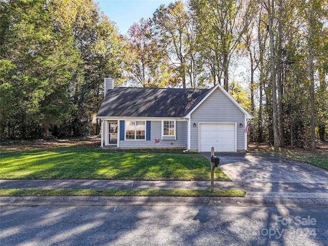 view of front of home with a front yard and a garage