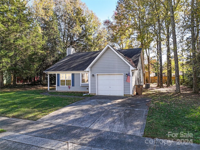 view of front of property featuring a front yard and a garage