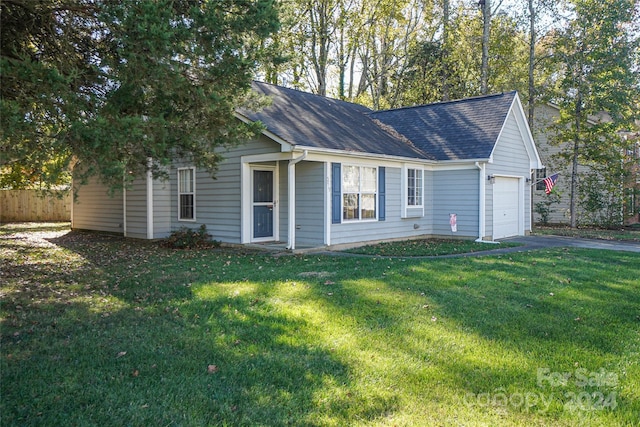 view of side of property with a garage and a lawn