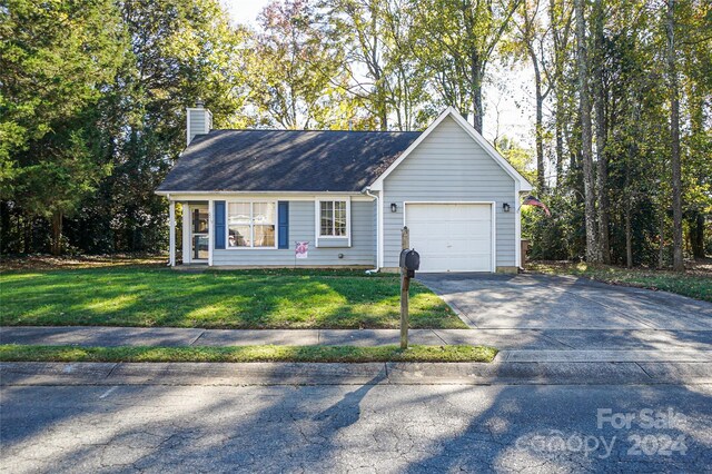 ranch-style home with a front yard and a garage