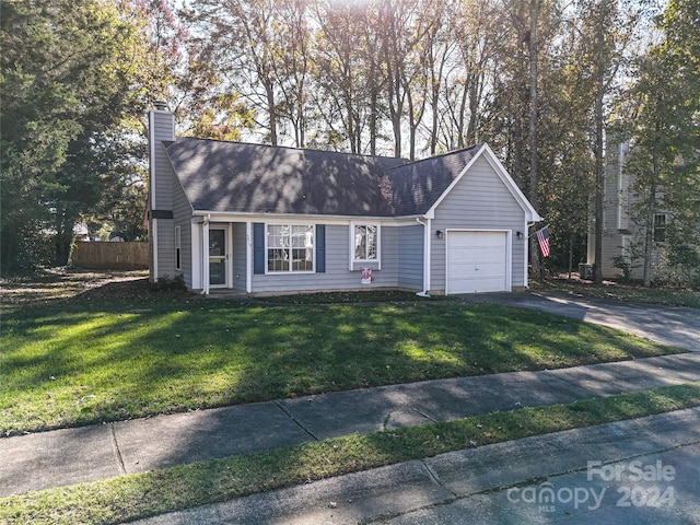 view of front of property with a front lawn and a garage