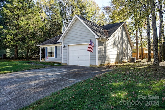 view of side of home with central air condition unit, a lawn, and a garage