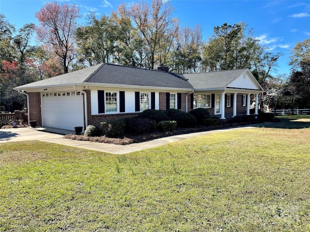 5486 Kershaw Camden Hwy, Heath Springs, SC 29058 - view of front of property featuring brick siding, a garage, driveway, a chimney, and covered porch