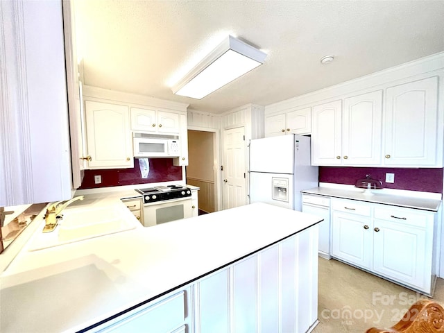 kitchen featuring sink, white cabinets, and white appliances