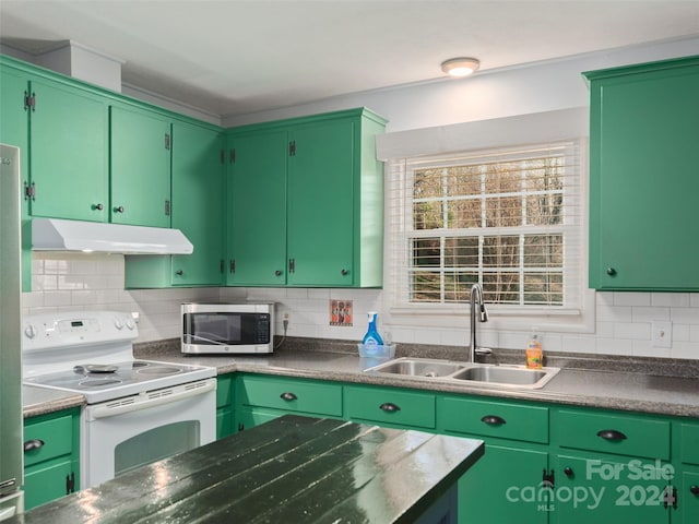 kitchen with sink, green cabinetry, and electric stove