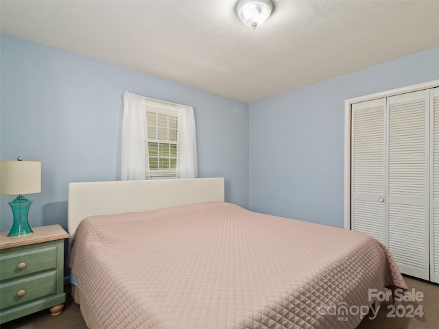 carpeted bedroom with a closet