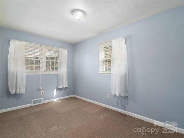 unfurnished room with carpet floors