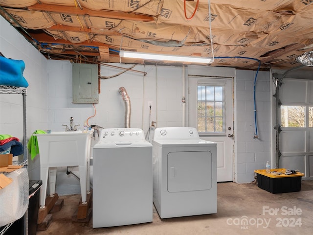 laundry area featuring electric panel and washing machine and dryer