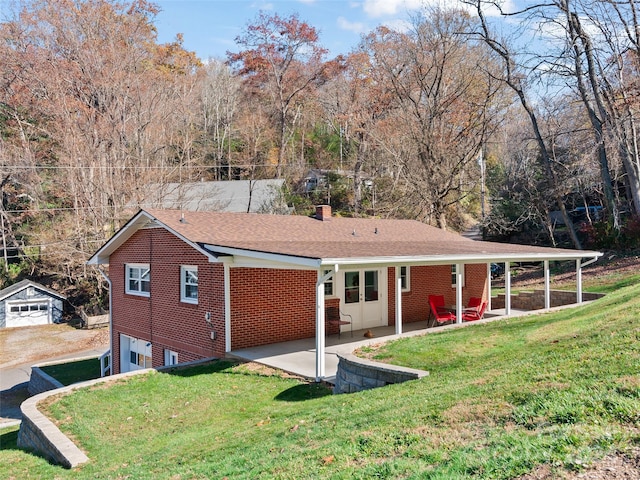 rear view of property featuring a lawn and a patio area