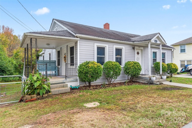 view of front of property with covered porch and a front lawn