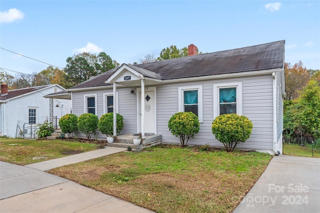 bungalow-style house with a front yard