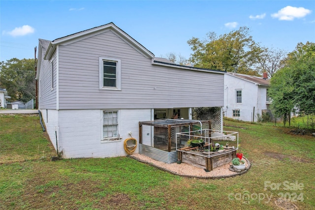 rear view of property featuring a yard