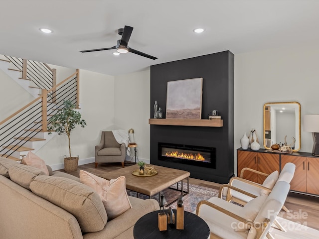 living room with ceiling fan and wood-type flooring