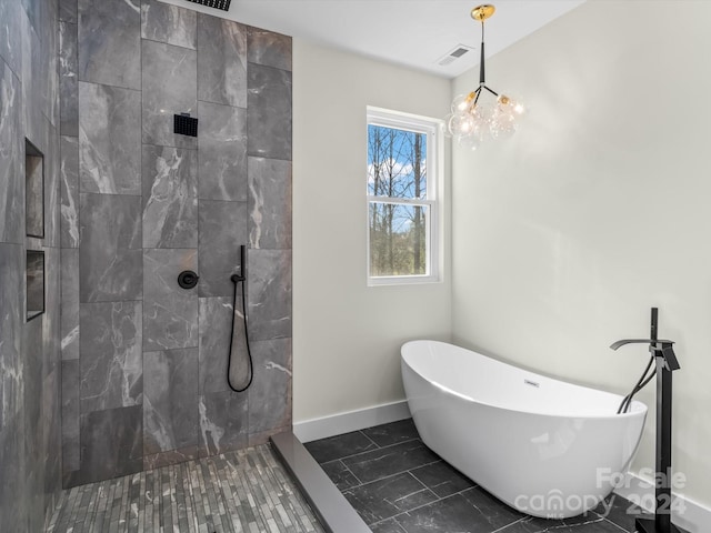 bathroom featuring a notable chandelier and independent shower and bath