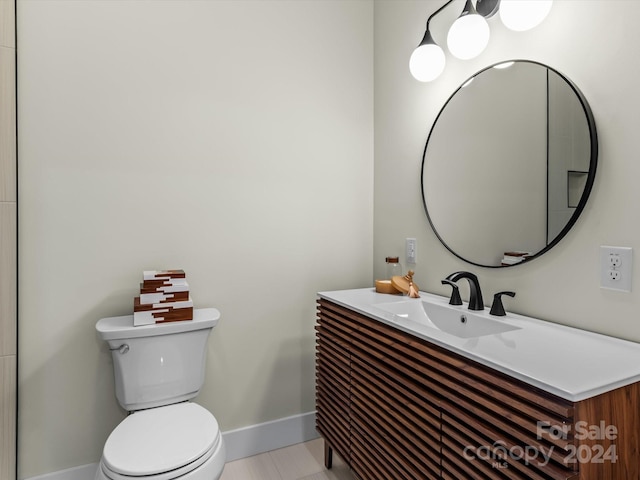 bathroom with tile patterned floors, vanity, and toilet