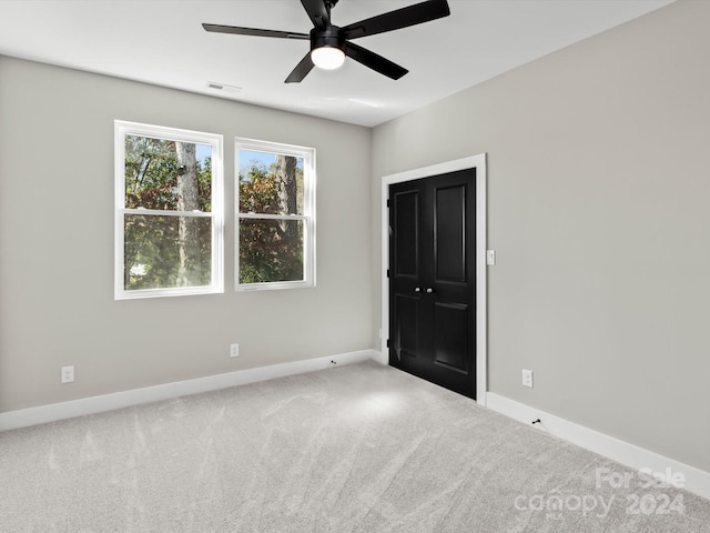 carpeted empty room featuring ceiling fan