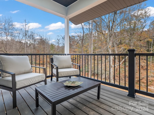 wooden terrace featuring outdoor lounge area