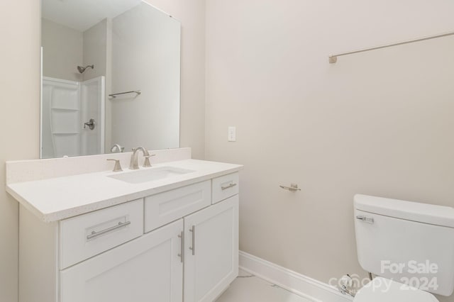 bathroom with walk in shower, vanity, and toilet