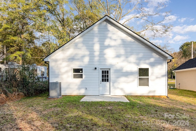 back of property with a patio area, a yard, and central AC unit