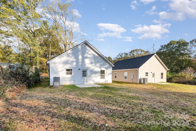 back of property featuring central AC, a lawn, and a patio