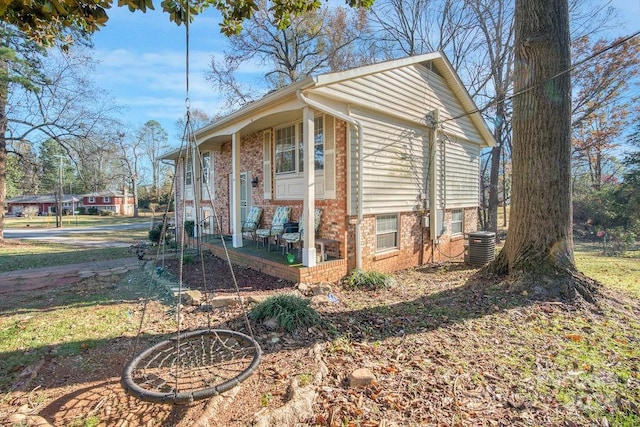 view of property exterior featuring central AC and a porch