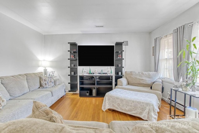 living room with hardwood / wood-style floors and a baseboard radiator