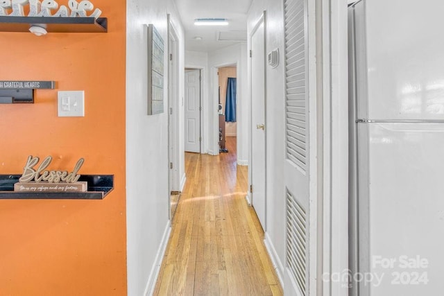 hallway with light hardwood / wood-style flooring