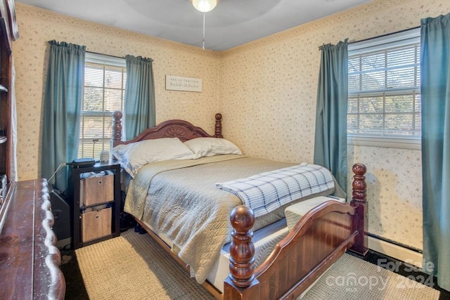 bedroom featuring a baseboard radiator and ceiling fan