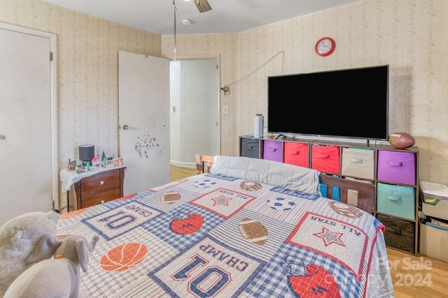 bedroom with ceiling fan and light hardwood / wood-style floors