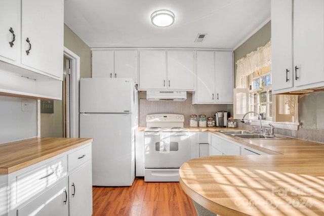 kitchen with white cabinetry, white appliances, exhaust hood, and light hardwood / wood-style flooring