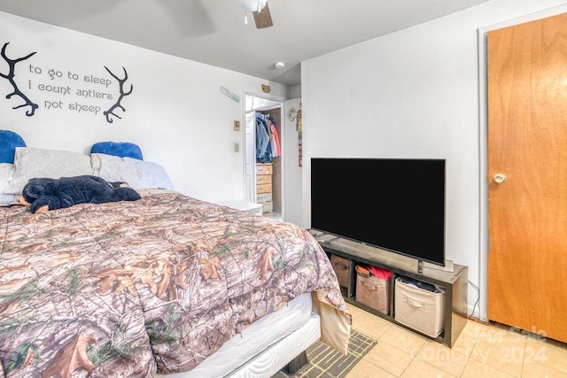 tiled bedroom featuring ceiling fan