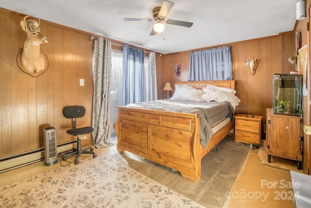 bedroom with ceiling fan and wood walls