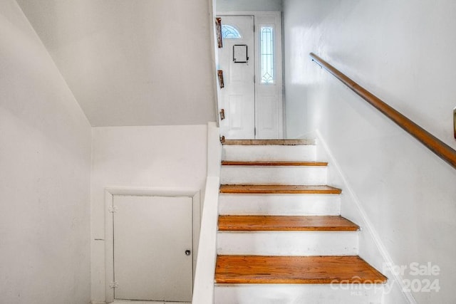 stairway with lofted ceiling