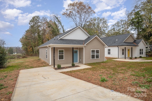 view of front of property with a porch and a front lawn