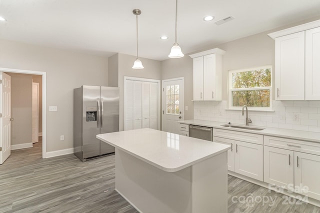 kitchen featuring sink, white cabinets, stainless steel appliances, and plenty of natural light