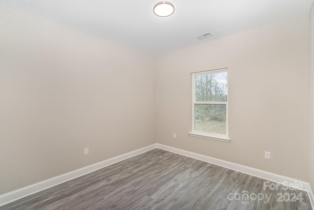 spare room featuring dark hardwood / wood-style floors